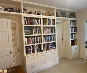 White bookcase with white drawers on the bottom