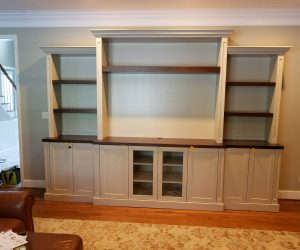 White bookcase with wood shelves and white cabinets on the bottom