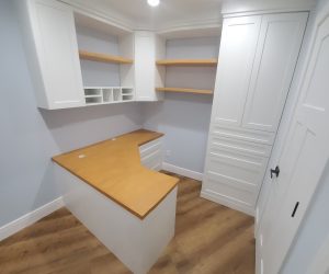 White cabinets and drawers with wood shelves